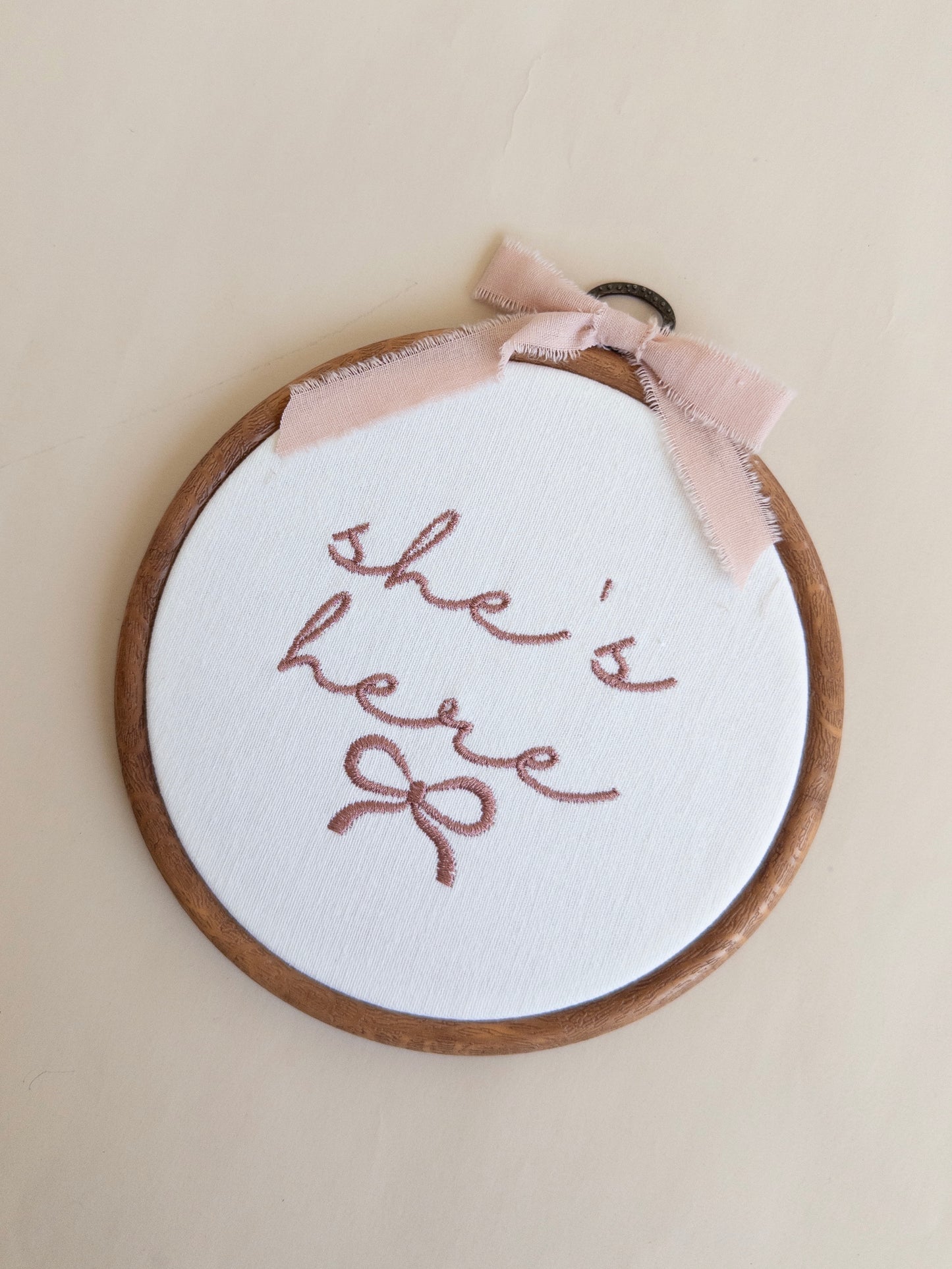 She's Here Embroidered Hoop Sign
