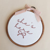 She's Here Embroidered Hoop Sign