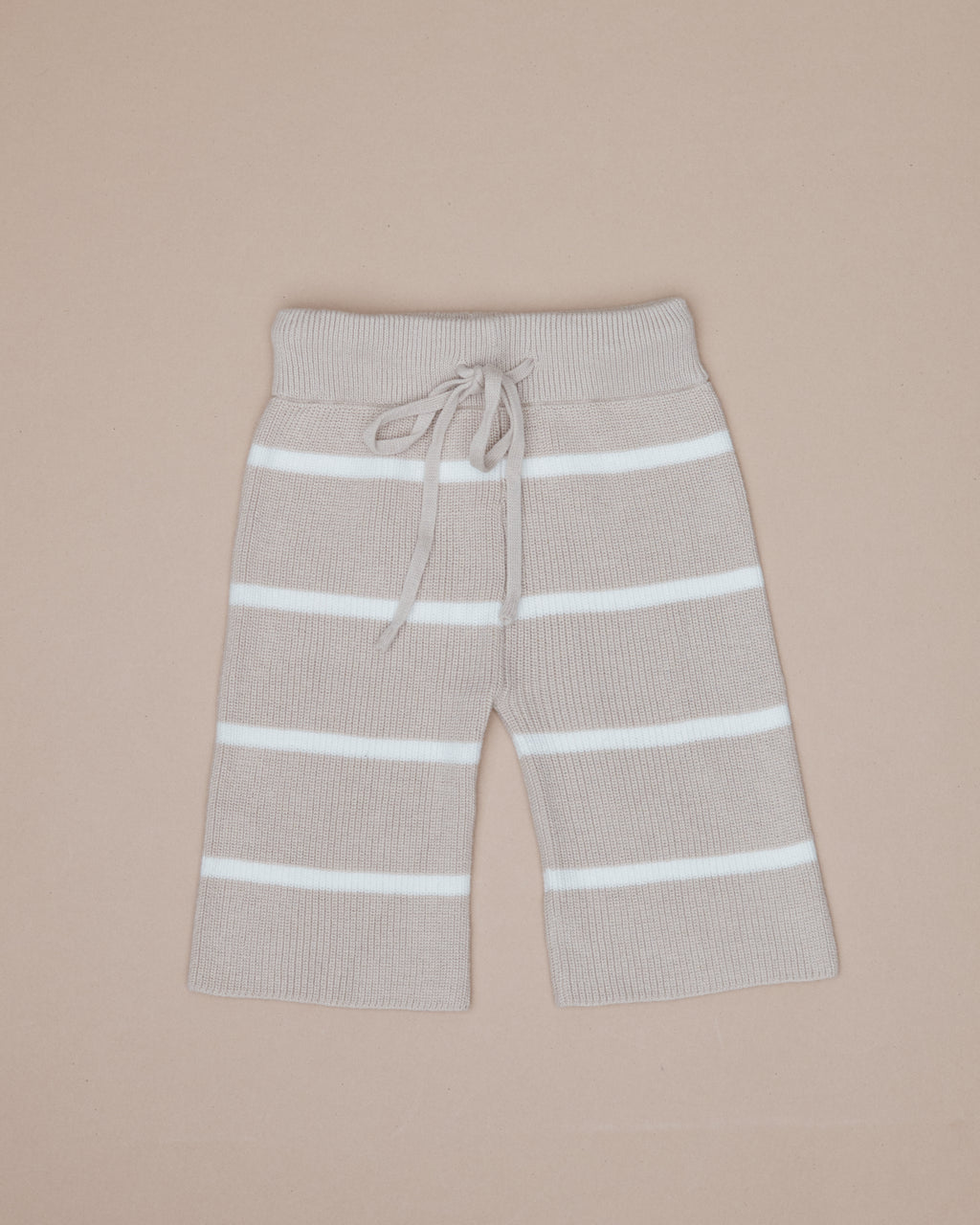 Beige pants with white stripes on a beige background