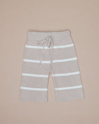 Beige pants with white stripes on a beige background