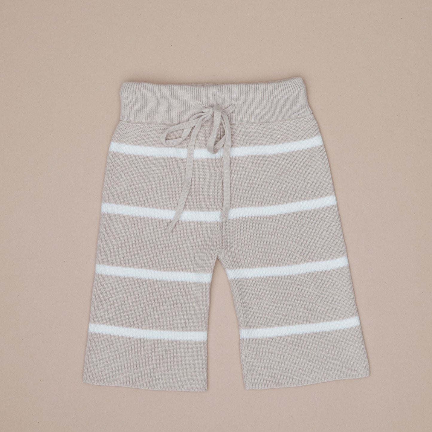 Beige pants with white stripes on a beige background