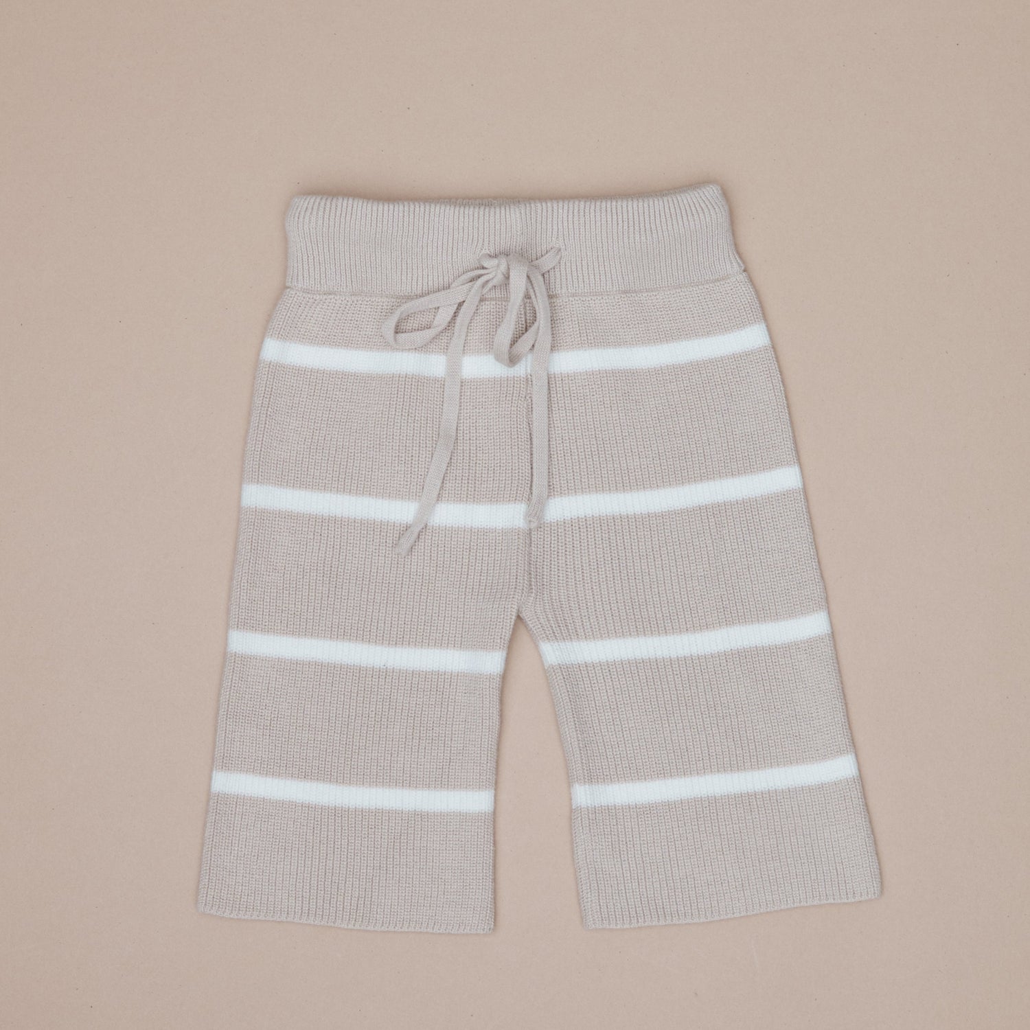 Beige pants with white stripes on a beige background