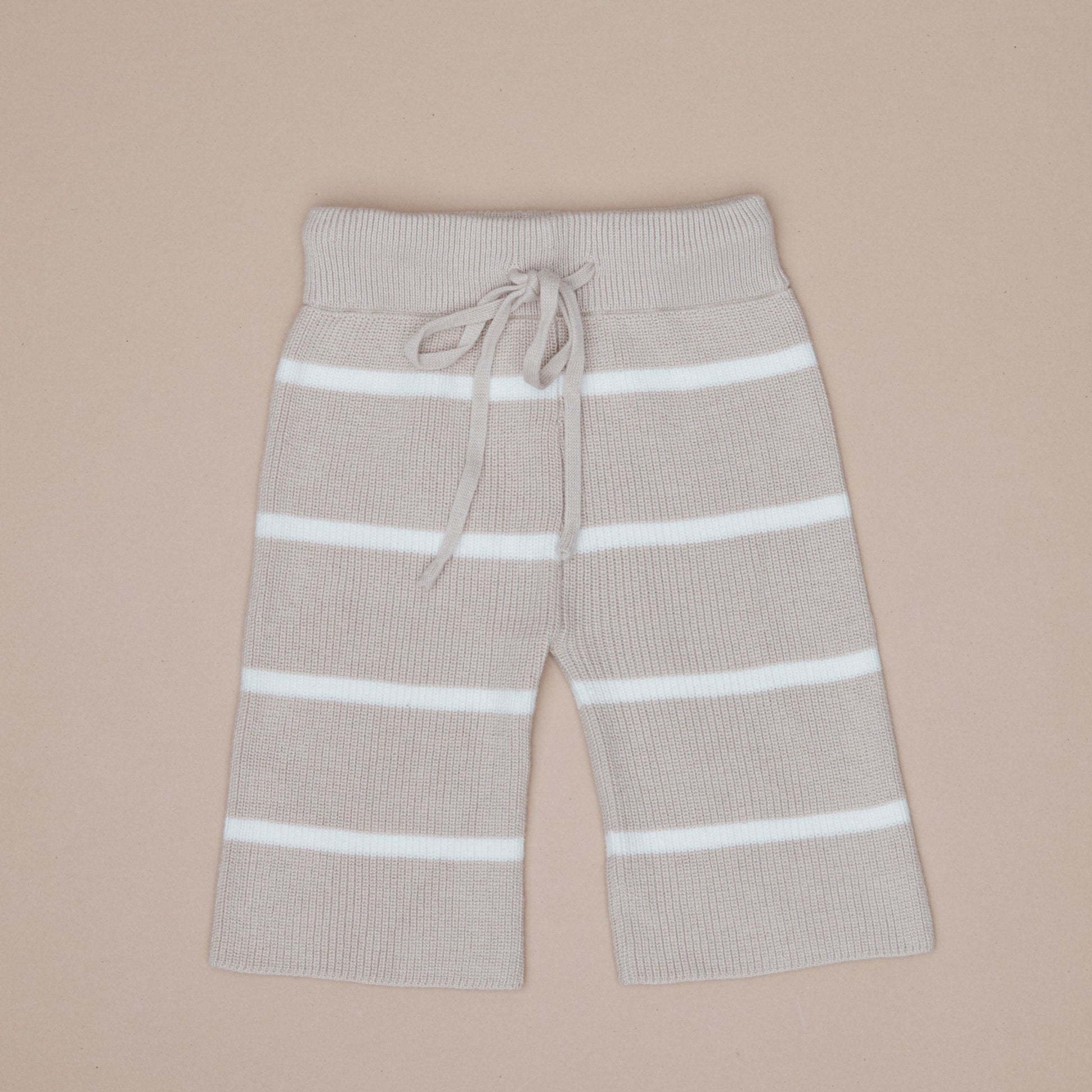 Beige pants with white stripes on a beige background