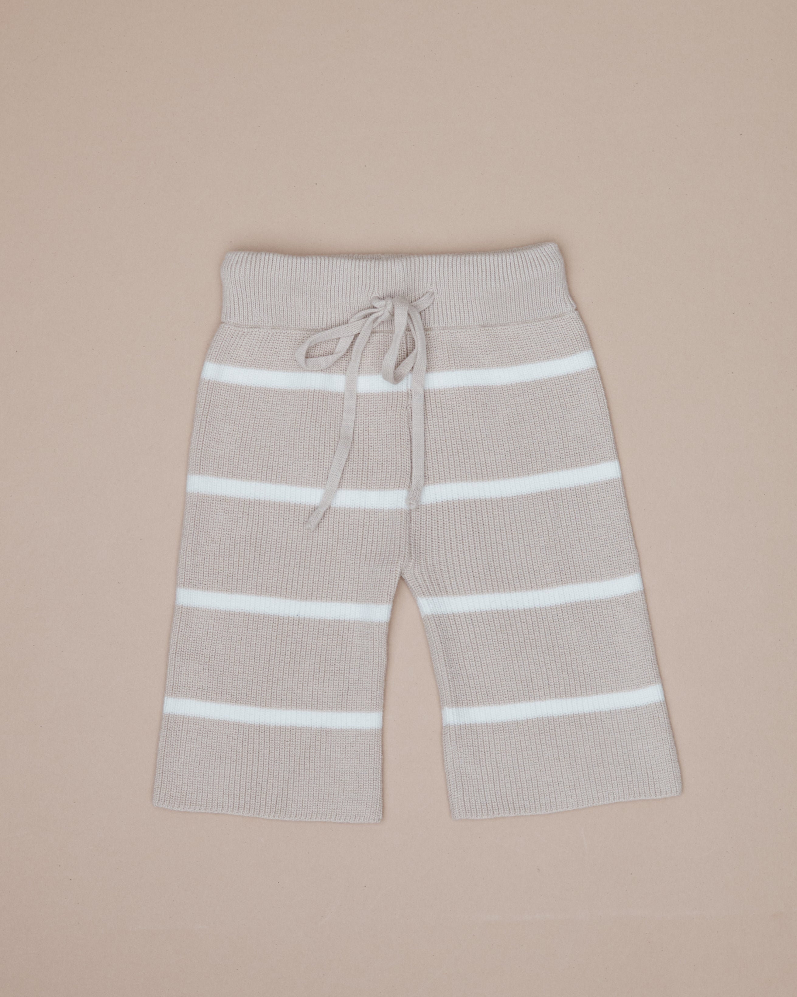 Beige pants with white stripes on a beige background