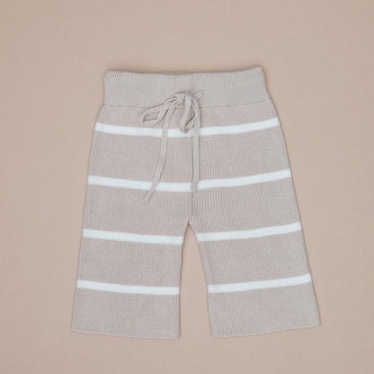 Beige pants with white stripes on a beige background