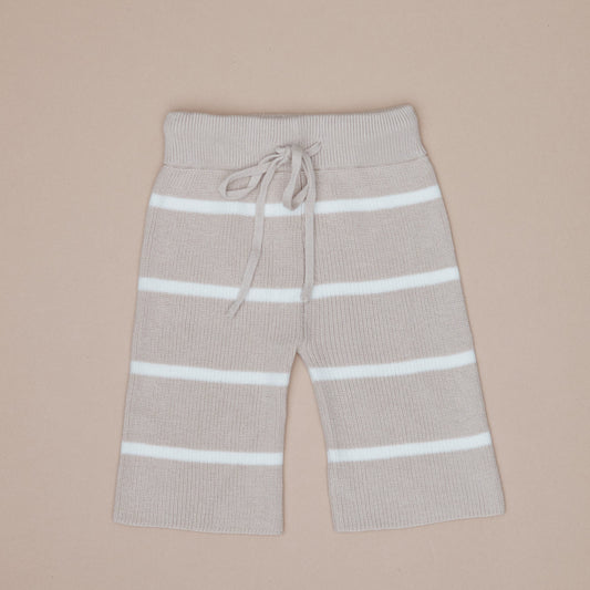 Beige pants with white stripes on a beige background
